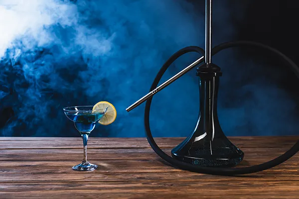 a hookah sits on a table next to a cocatil
